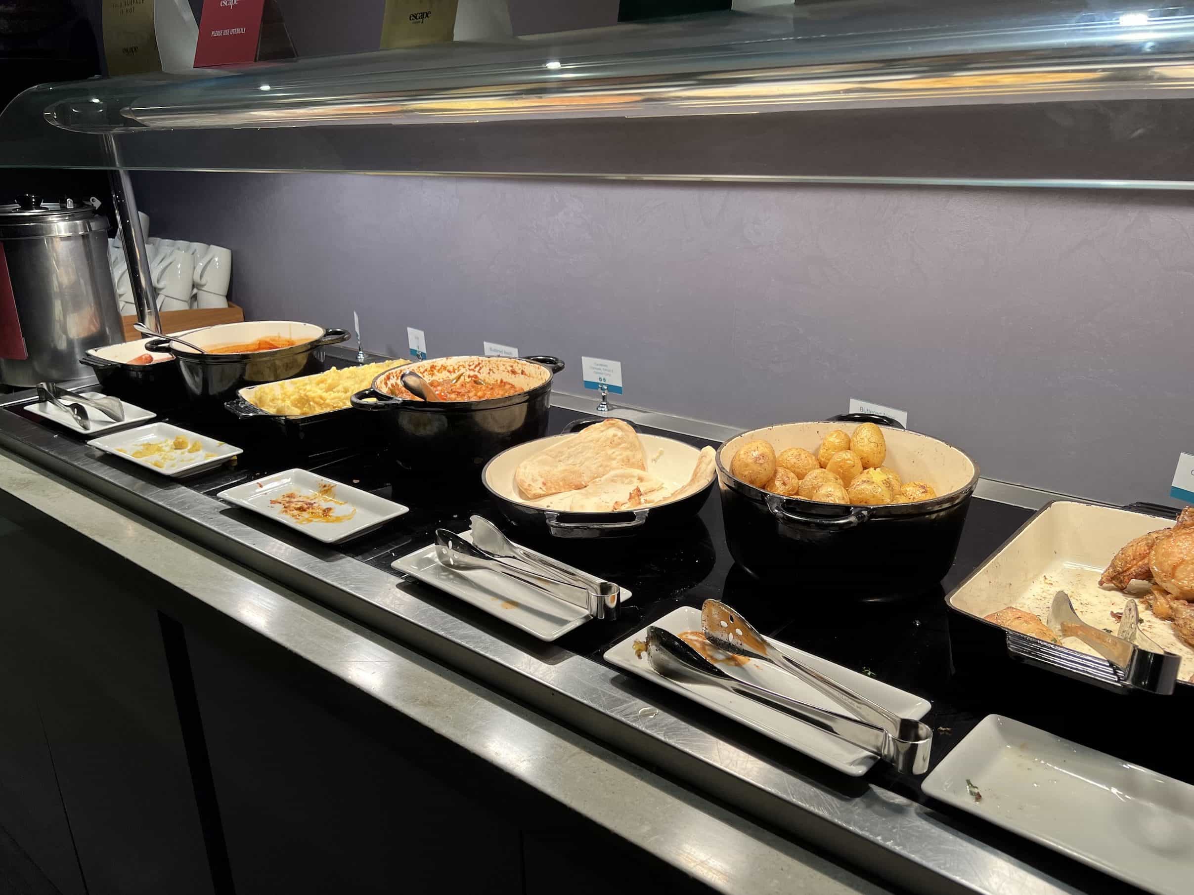 A selection of hot buffet food including chicken, curry, carbonara and potatoes